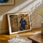 Photo mosaic portrait of a man in sunglasses standing against a textured wall, framed and displayed in a sunlit hallway.