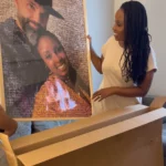 Woman unboxing a custom photo mosaic print of a couple, smiling as she lifts it from the shipping box.
