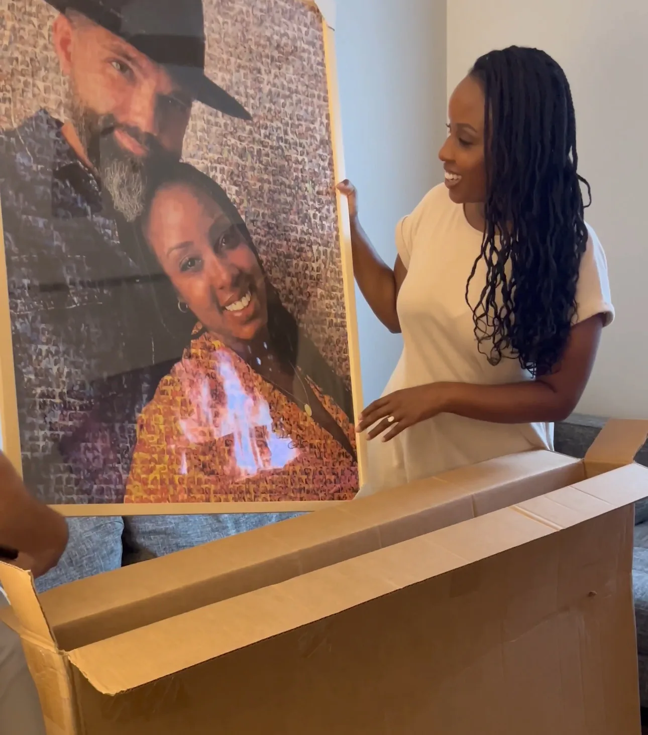 Surprise Gift for Wife Photo Mosaic Woman unboxing a custom photo mosaic print of a couple, smiling as she lifts it from the shipping box.