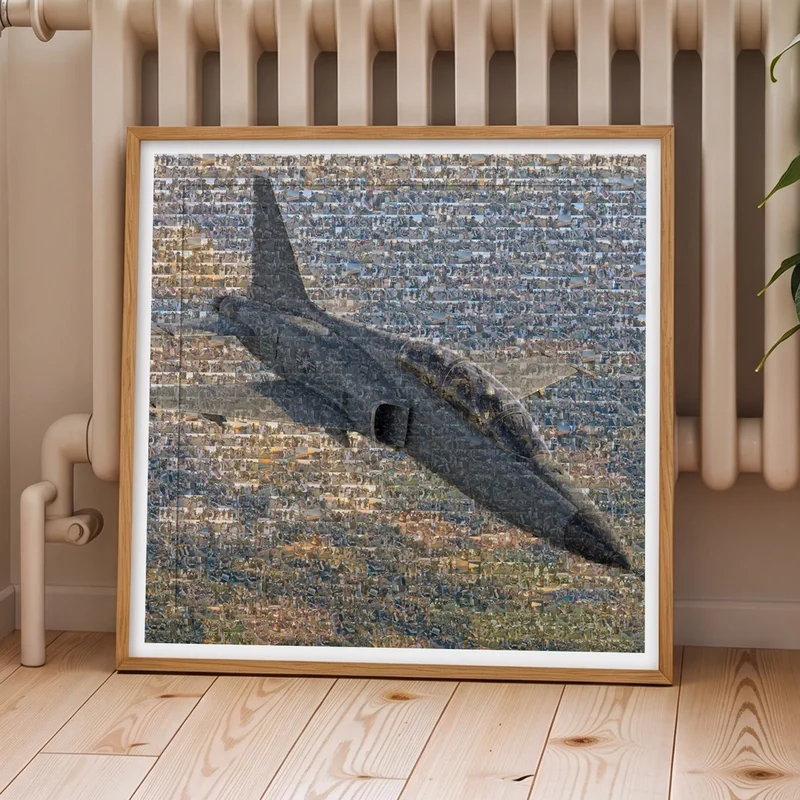 A framed photo mosaic of a U.S. Air Force training jet, made from service photos, leaning against a wall